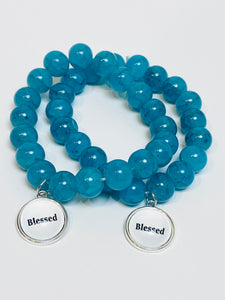 Teal beaded stretch bracelet with charm