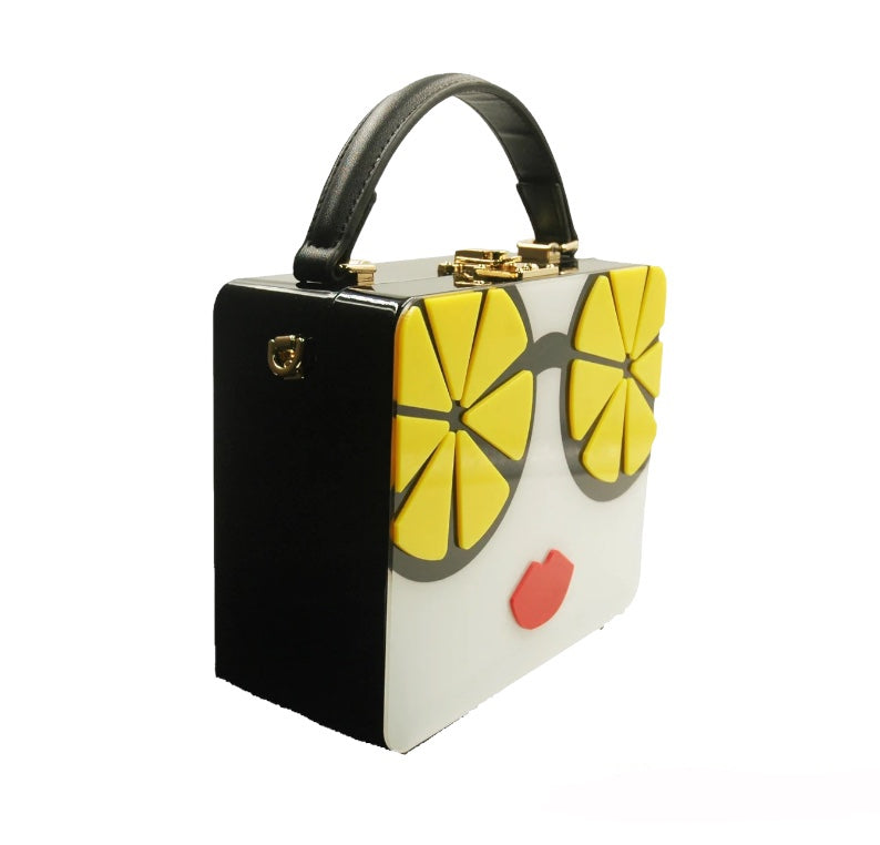 Unique acrylic black purse adorned with yellow lemons 